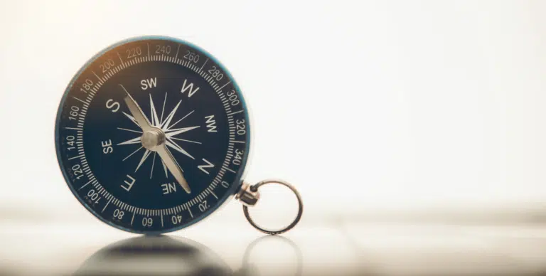 the-blue-compass-is-placed-on-background-1980x1001-min